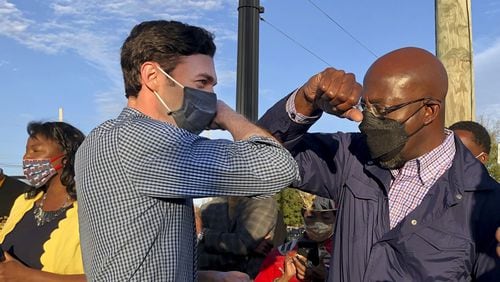 Georgia's Democratic U.S. Senate candidates Jon Ossoff, left, and Raphael Warnock tap elbows during a rally for supporters on November 15, 2020, in Marietta, Georgia. (Jenny Jarvie/Los Angeles Times/TNS)