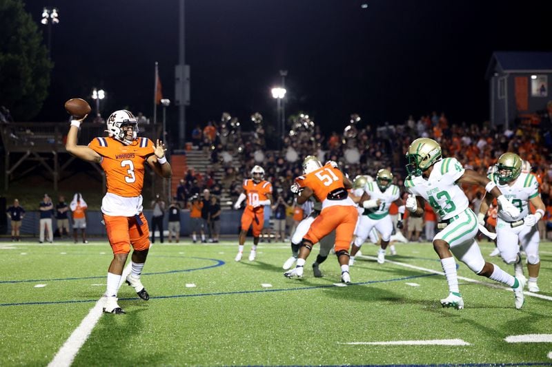North Cobb quarterback Malachi Singleton (3) throws under pressure from Buford linebacker Malik Spencer (43) for a touchdown during the first half Friday, Aug. 20, 2021, in Kennesaw. (Jason Getz/For the AJC)


