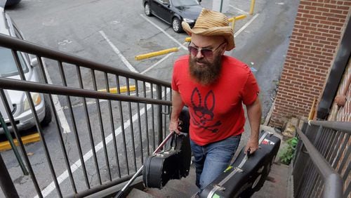 Singer/songwriter Angie Aparo carries in his equipment before his performance at Eddie’s Attic in Decatur in May.