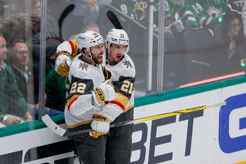 Vegas Golden Knights center Brett Howden (21) celebrates his second period goal with Michael Amadio (22) in Game 7 of an NHL hockey Stanley Cup first-round playoff series against the Dallas Stars, Sunday, May 5, 2024, in Dallas. (AP Photo/Brandon Wade)