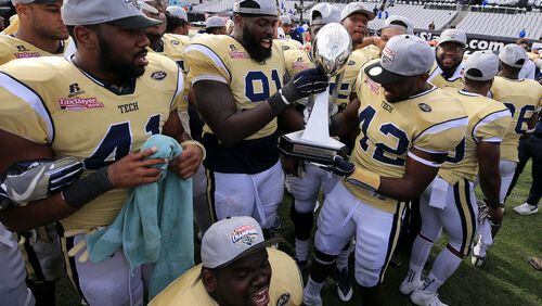 Georgia Tech Yellow Jackets players celebrate after defeating the Kentucky Wildcats to win the TaxSlayer Bowl at EverBank Field on December 31, 2016 in Jacksonville, Florida. (Photo by Rob Foldy/Getty Images)