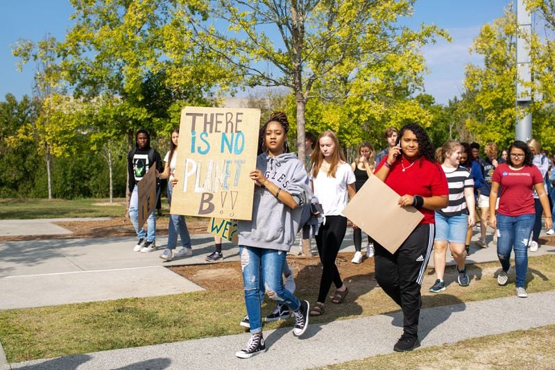 Students walk onto the football field for an organized school-wide climate walkout on Thursday, Sept. 26, 2019, in Atlanta, Georgia. North Atlanta High School, along with other Atlanta Public Schools, walked out on Thursday and Friday, Sept. 27, to call for action against climate change. (Photo/Rebecca Wright for the Atlanta Journal Constitution)