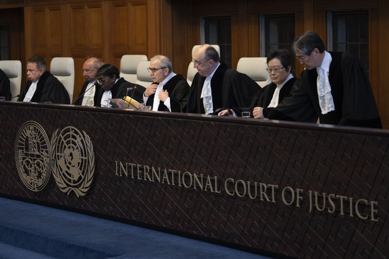 Presiding judge Nawaf Salam, fourth from right, opens the court session of the International Court of Justice in The Hague, Netherlands, Tuesday, April 30, 2024, where the United Nations' top court is ruling on a request by Nicaragua for judges to order Germany to halt military aid to Israel, arguing that Berlin's support enables acts of genocide and breaches of international humanitarian law in Gaza. (AP Photo/Peter Dejong)