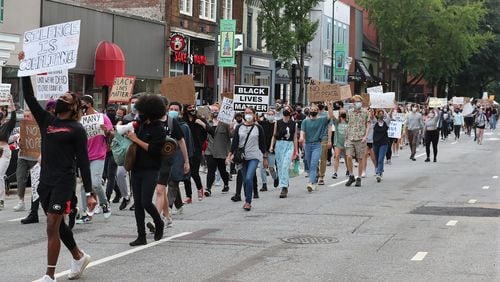 University of Georgia students take to the streets and march down East Clayton Street from the UGA arch during a Black Lives Matter protest in support of Breonna Taylor on Sept. 25 in Athens. (Curtis Compton / Curtis.Compton@ajc.com)