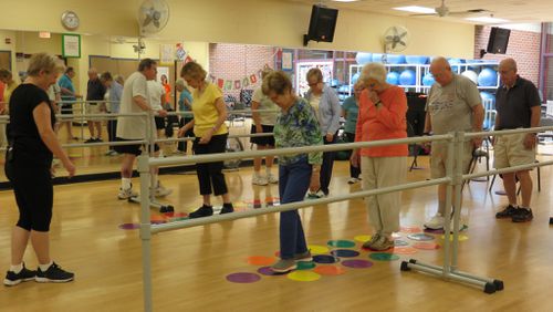 Fitness instructor Katy Pate (left) leads a Parkinson’s support class at the McCleskey-East Cobb Family YMCA. Free six-month YMCA family memberships are available for those with Parkinson’s thanks to a grant from the National Parkinson Foundation. Contributed by Laura Berrios