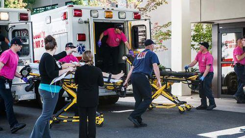 A patient is wheeled into the emergency room at Mercy Medical Center in Roseburg, Ore., following a deadly shooting at Umpqua Community College, in Roseburg, Thursday, Oct. 1, 2015. (Aaron Yost/Roseburg News-Review via AP)