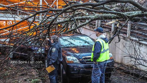 The Lowergate parking deck at Emory University Hospital was blocked Wednesday morning by a fallen tree. The tree came down on two vehicles entering the deck, forcing their drivers to crawl out from underneath the branches.