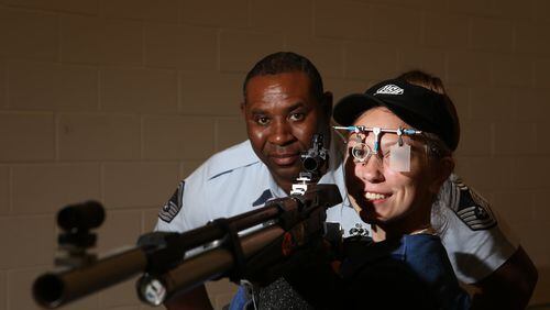 Rayven Fincher, 16 (right), a sophomore at Monroe Area High School, poses with her competition air rifle and Air Force JROTC SMSgt. Clay Slaton at their indoor training facility in Monroe, Georgia, on May 2, 2017. Fincher took the state champion title at “The Dixie Double” at Fort Benning and only missed qualifying for the Junior Olympics by one point. After breaking her spine in a car accident last year and losing nearly six months of practice time, her trajectory is unmatched, and she hopes to continue it and qualify for the Olympics one day. (HENRY TAYLOR / HENRY.TAYLOR@AJC.COM)
