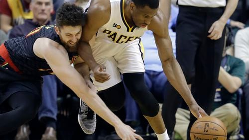 Atlanta Hawks’ Ryan Kelly, left, and Indiana Pacers’ Thaddeus Young vie for a loose ball during the first half of an NBA basketball game Wednesday, April 12, 2017, in Indianapolis. (AP Photo/Darron Cummings)