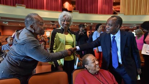 Mike Thurmond, who won the race for DeKalb County CEO on Tuesday, greets seniors Elayn Ansari and Helen Norris during at forum at Salem Bible Church in Lithonia on May 5. HYOSUB SHIN / HSHIN@AJC.COM