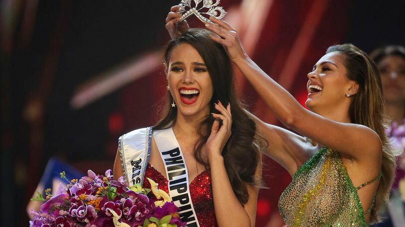 Catriona Gray of the Philippines, left, reacts with joy as she is crowned the Miss Universe 2018 by Miss Universe 2017 Demi-Leigh Nel-Peters during the final round of the 67th Miss Universe competition in Bangkok, Thailand, Monday, Dec. 17, 2018.(AP Photo/Gemunu Amarasinghe)