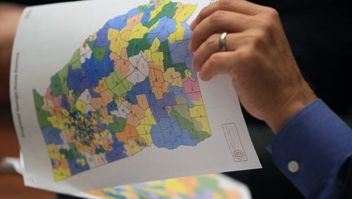 A lawmaker looks over a map of Georgia's political districts on Aug.  23, 2011. AJC file photo.