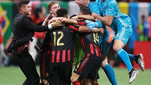 Atlanta United players rush the field to celebrate as time expires in a 2-1 victory over Minnesota United to win the U.S. Open Cup on Tuesday, August 27, 2019, in Atlanta.  Curtis Compton/ccompton@ajc.com