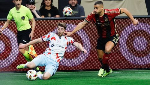Atlanta United forward Giorgos Giakoumakis (7) battles for the ball against Chicago Fire defender Jonathan Dean (24) during the first half against the Chicago Fire at Mercedes-Benz Stadium on Sunday, March 31, 2024.
 Miguel Martinez / miguel.martinezjimenez@ajc.com