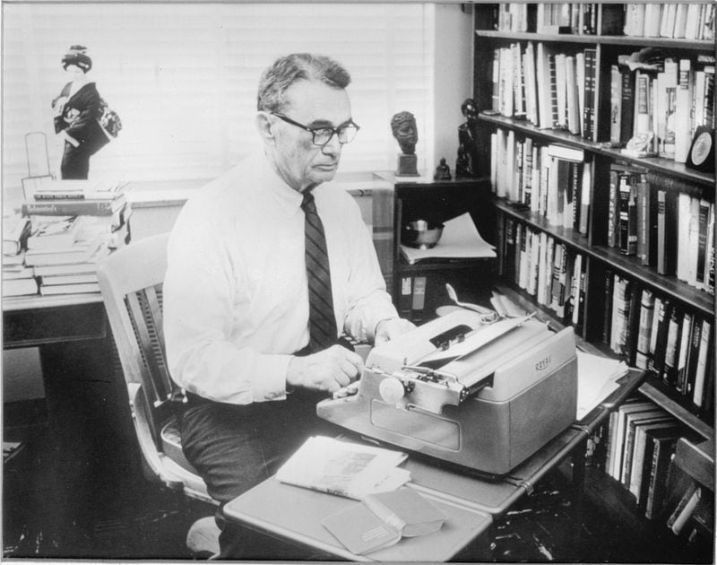 Atlanta Constitution editor Ralph M. McGill writing at his old Royal typewriter.