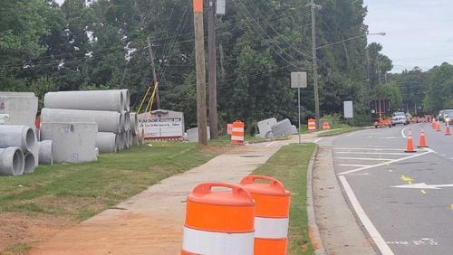 Construction is underway at Grogans Ferry and Roswell Road in Sandy Springs. Huge concrete cylinders currently resting on each side of the road are drainage pipes for the new storm drainage system.  (Courtesy City of Sandy Springs)