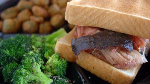 Barbecue pork sandwiches (along with other choices) are served with sides that include broccoli and fried okra