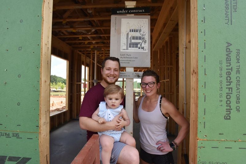Spenser and Cory Hewett with their 15-month-old son Eliot at the construction of their new house in the Pinewood Forest community in Fayetteville on Saturday, June 22, 2019. Spenser and Cory Hewett are millennials who have left their life in Buckhead for Fayette County, metro Atlanta’s oldest county by age. HYOSUB SHIN / HSHIN@AJC.COM