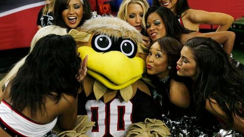 In this file photo, Freddie Falcon shows why he’s the (bird)man of football mascots as he’s swarmed by Falcons cheerleaders. In a battle of the birds, a falcon has it all over Seattle’s seahawk. Curtis Compton, ccompton@ajc.com