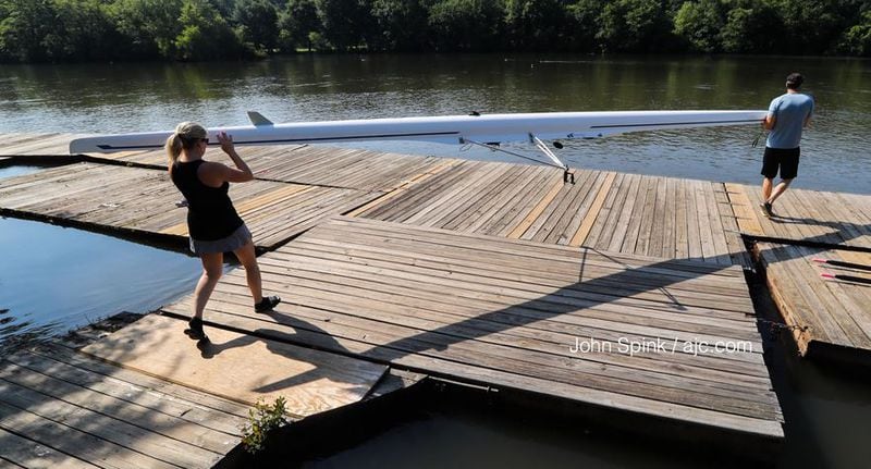 Atlanta rowing club members Sherry vom Saal (left) and Frank Torres get ready to head out on the Chattahoochee River amid clear skies Friday. JOHN SPINK / JSPINK@AJC.COM
