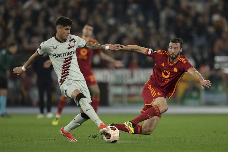 Leverkusen's Granit Xhaka, left, and Roma's Bryan Cristante fight for the ball during the UEFA Europa League semifinal first leg soccer match between AS Roma and Bayer 04 Leverkusen at the Olympic stadium in Rome, Italy, Thursday, May 2, 2024. (Alfredo Falcone/LaPresse via AP)