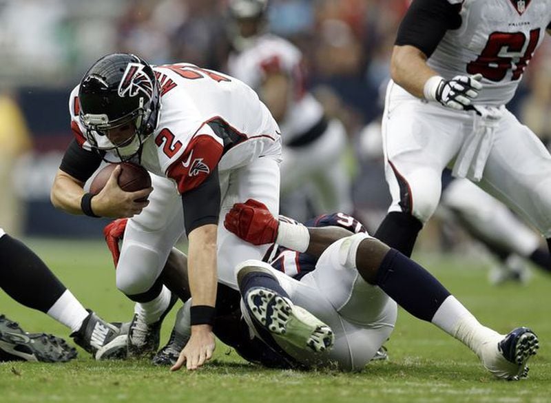 Atlanta Falcons' Matt Ryan (2) is sacked by Houston Texans' Jadeveon Clowney, right, during the first quarter of an NFL preseason football game Saturday, Aug. 16, 2014, in Houston. (AP Photo/Patric Schneider)