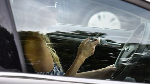 Like adults, teenage drivers in Georgia can use their phones while driving - as long as they use hands-free technology. HYOSUB SHIN / HSHIN@AJC.COM