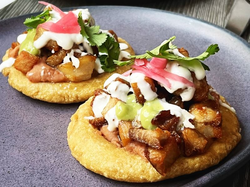 El Valle's sopes de carnitas feature pork belly piled on top of sopes made by chef Executive Chef Luis Damian's mother. Henri Hollis/henri.hollis@ajc.com