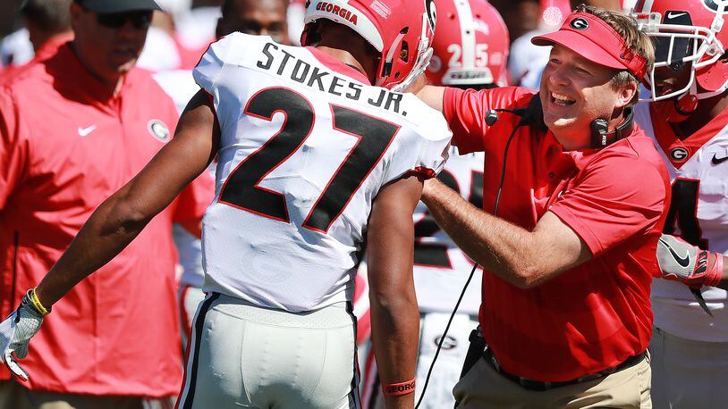 Georgia coach Kirby Smart celebrates with defensive back Eric Stokes after he blocked a punt by Missouri punter Corey Fatony and returned it for a touchdown for a 20-7 lead during the second quarter Saturday, Sept 22, 2018, in Columbia.  Curtis Compton/ccompton@ajc.com