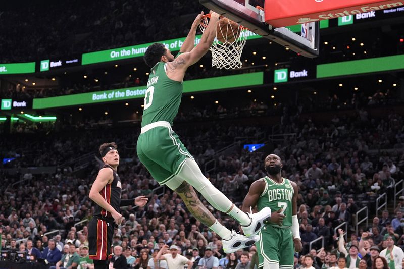 Boston Celtics forward Jayson Tatum (0) slams a dunk against the Miami Heat during the first half of Game 2 of an NBA basketball first-round playoff series, Wednesday, April 24, 2024, in Boston. (AP Photo/Charles Krupa)