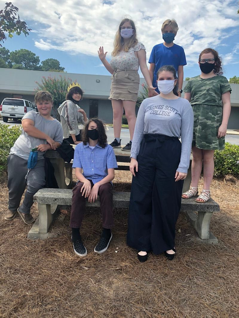 Junior high students at the Academy, a hybrid home school option for students that combines in-person and self-directed learning, are pictured with Karen Seaver, a student teacher from Agnes Scott. Image courtesy of the Academy.