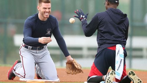 Braves first baseman Freddie Freeman  (lefts) works with coach Ron Washington during a recent workout.  Curtis Compton/ccompton@ajc.com