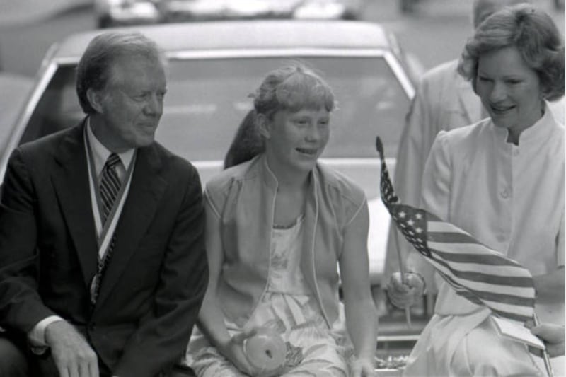 Former President Jimmy Carter, grand marshal of the Salute 2 America parade, rode in an open car with First Lady Rosalynn Carter and daughter Amy on July 4, 1981.  (AJC Photographic Archive, Georgia State University Library)