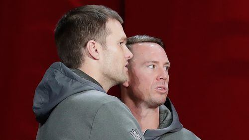New England quarterback Tom Brady and his Falcons counterpart Matt Ryan share a moment Monday between their media sessions at Super Bowl Opening Night. (Tim Warner/Getty Images)
