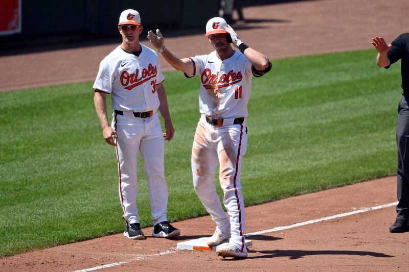 Baltimore Orioles' Jordan Westburg (11) gestures at third base after he drove in two runs with a triple during the fifth inning of a baseball game against the New York Yankees, Thursday, May 2, 2024, in Baltimore. Orioles third base coach Tony Mansolino is at left. (AP Photo/Nick Wass)