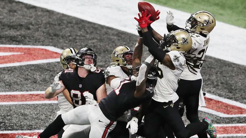 New Orleans Saints defenders defend a Hail Mary pass to Atlanta Falcons wide receiver Julio Jones in the end zone as time expires Sunday, Dec. 6, 2020, at Mercedes-Benz Stadium in Atlanta. (Curtis Compton / Curtis.Compton@ajc.com)