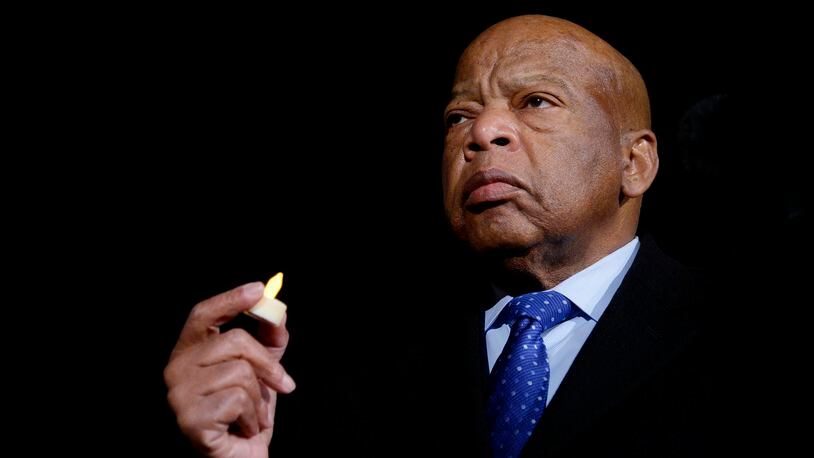 U.S. Rep. John Lewis holds a candle during an event in 2017 in front of the Supreme Court in Washington, D.C. Central Connecticut State University plans to open the John Lewis Institute for Social Justice in the fall to honor the late Georgia congressman, who died in 2020. (Olivier Douliery/Abaca Press/TNS)