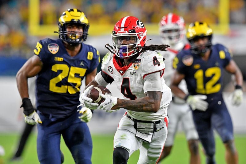 Georgia Bulldogs running back James Cook (4) scores on a 39-yard touchdown catch during the fourth quarter against the Michigan Wolverines in the 2021 College Football Playoff Semifinal at the Orange Bowl at Hard Rock Stadium, Friday, in Miami Gardens, Fl. (Hyosub Shin / Hyosub.Shin@ajc.com)