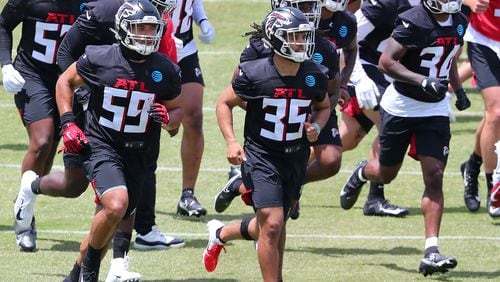 Falcons outsider linebacker Alani Pututau (from left) and cornerbacks Avery Williams and Darren Hall lead the way to the next drills during rookie minicamp on Friday, May 14, 2021, in Flowery Branch.     “Curtis Compton / Curtis.Compton@ajc.com”