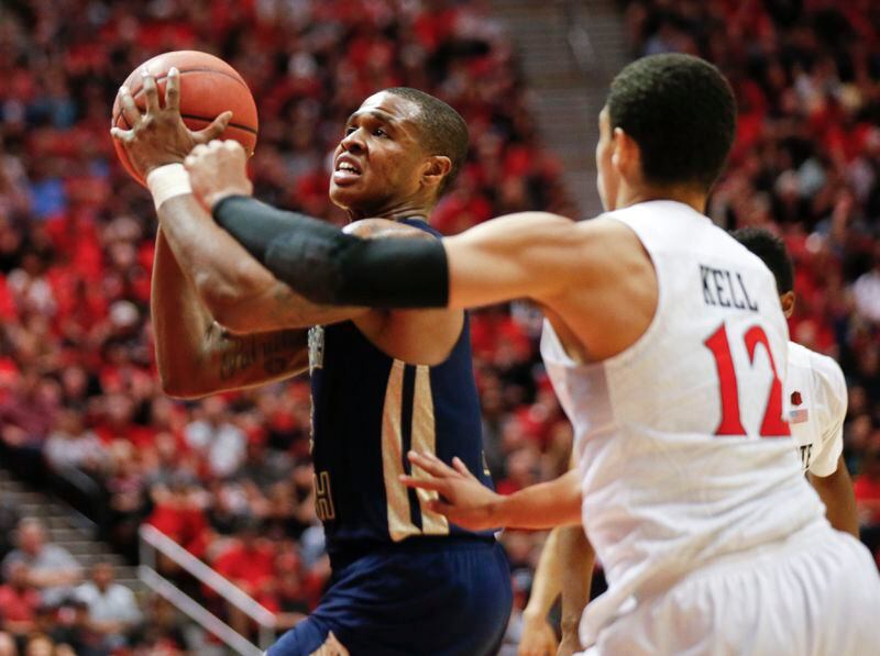 Georgia Tech guard Marcus Georges-Hunt is fouled by San Diego State guard Trey Kell while driving to the basket during the second half in an NCAA college basketball game in the men's NIT, Wednesday, March 23, 2016, in San Diego. (AP Photo/Lenny Ignelzi)