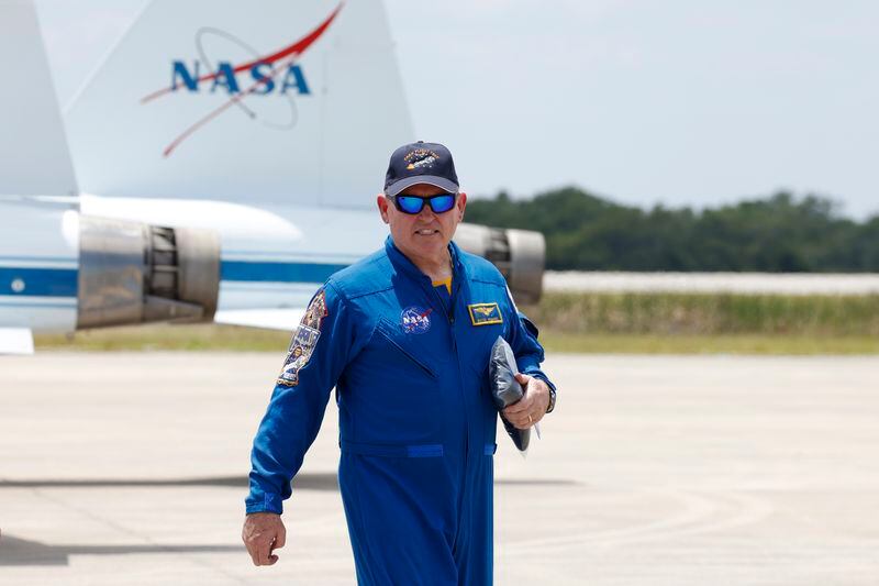 NASA astronaut Butch Wilmore, walks past NASA jets after he arrived at the Kennedy Space Center, Thursday, April 25, 2024, in Cape Canaveral, Fla. The crew of two test pilots will launch aboard Boeing's Starliner capsule atop an Atlas rocket to the International Space Station, scheduled for liftoff on May 6, 2024. (AP Photo/Terry Renna)