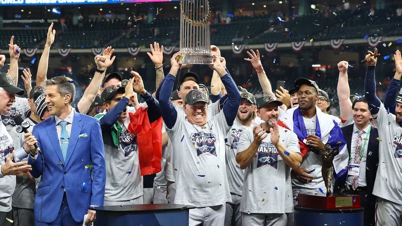 110221 HOUSTON: Braves manager Brian Snitker hoists the World Series trophy after beating the Astros in game 6 of the World Series on Tuesday, Nov. 2, 2021, in Houston.   “Curtis Compton / Curtis.Compton@ajc.com”