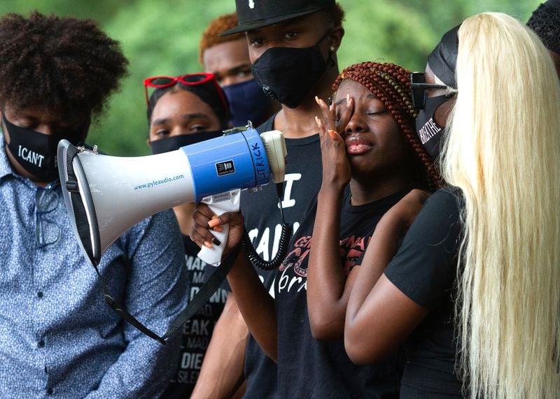 Audrey Grice becomes emotional while relaying a personal story to the crowd during Teens Looking For Change rally at Piedmont Park.