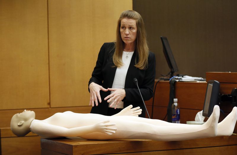 4/12/18 - Atlanta -  Tex and Diane McIver's masseuse, Annie Anderson, demonstrates a "polarity rock" she  used on Tex McIver as he slept fitfully after his wife’s death. Bob Andres bandres@ajc.com