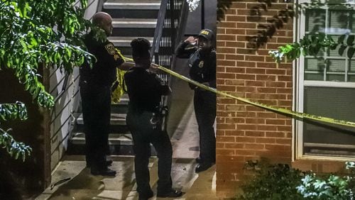 DeKalb County police officers blocked a grassy area outside a breezeway with crime scene tape after a man was found fatally shot Thursday morning at the Oak Forest Apartments in Scottdale.
