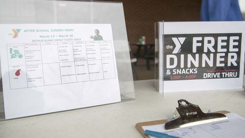 A sign up sheet and a menu are displayed during a meal giveaway at the Villages at Carver YMCA in the South Atlanta community of Atlanta, Tuesday, March, 17, 2020. May 5 marked #GivingTuesdayNow for charitable organizations supported by philanthropy. (ALYSSA POINTER/ALYSSA.POINTER@AJC.COM)