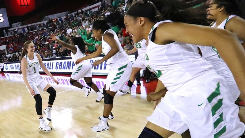  The Buford Wolves girls team rushes the court after winning the Class AAAAA state championship in 2017. (Curtis Compton/AJC)