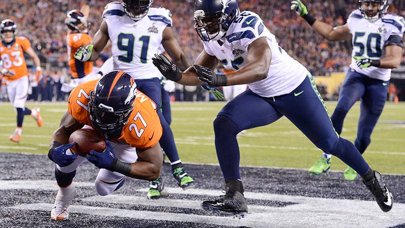Knowshon Moreno (27) of the Denver Broncos is tackled after picking up a loose ball that leads to a safety for the Seattle Seahawks in the end zone during the first half of Super Bowl XLVIII at MetLife Stadium in East Rutherford, N.J., on Sunday, Feb. 2, 2014. (Lionel Hahn/Abaca Press/MCT) Knowshon Moreno (27) of the Denver Broncos is tackled after picking up a loose ball that leads to a safety for the Seattle Seahawks in the end zone on the opening drive of Super Bowl XLVIII. At 12 seconds, that was the quickest score of any previous Super Bowl. (Lionel Hahn / Abaca Press)