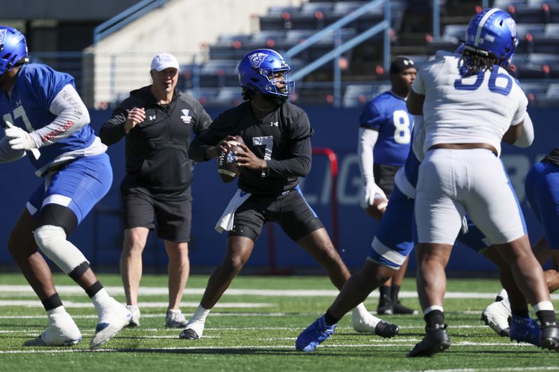 Georgia State quarterback Braylen Ragland (7) attempts a pass as head coach Shawn Elliott, second from left, watches during the first day of spring football practice at Center Parc Stadium, Tuesday, February 13, 2024, in Atlanta. (Jason Getz / jason.getz@ajc.com)