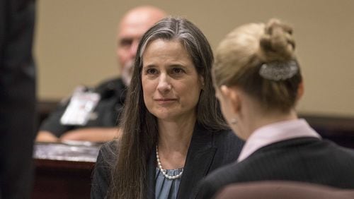 Nydia Tisdale sits with her lawyers during a trial at the Dawson Superior Court, Thursday, November 30, 2017. Tisdale was arrested at a Republican Party function in 2014 as she tried to videotape.